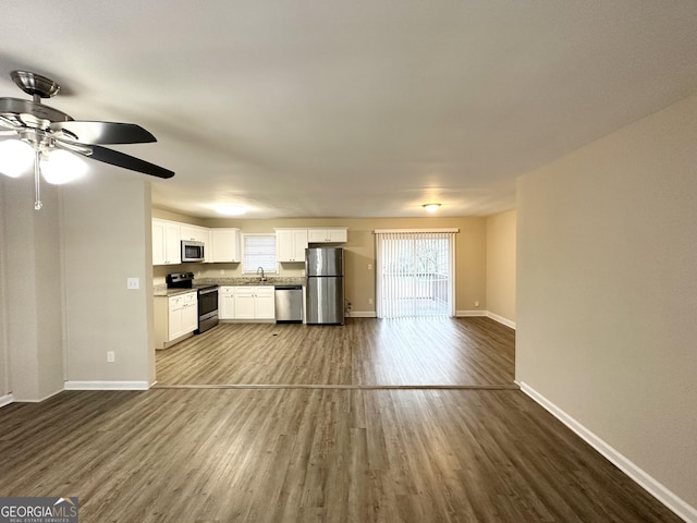 unfurnished living room featuring hardwood / wood-style floors and ceiling fan