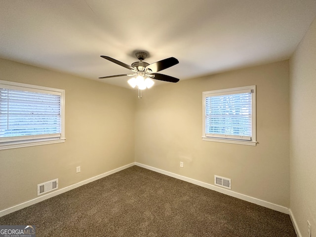 carpeted empty room featuring ceiling fan and a healthy amount of sunlight