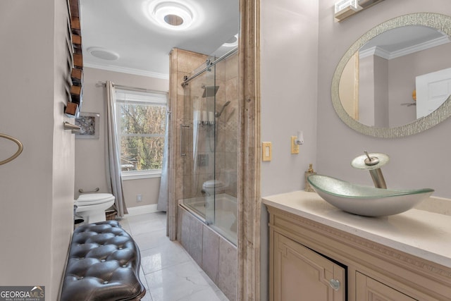 bathroom with crown molding, vanity, and combined bath / shower with glass door