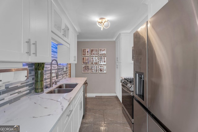 kitchen with sink, appliances with stainless steel finishes, white cabinetry, tasteful backsplash, and light stone counters