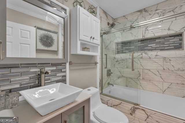 full bathroom with shower / bath combination with glass door, decorative backsplash, ornamental molding, vanity, and toilet