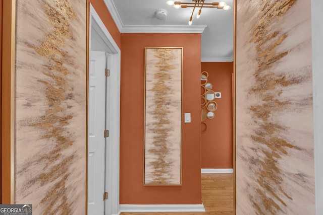 doorway to outside with crown molding, a chandelier, and hardwood / wood-style floors