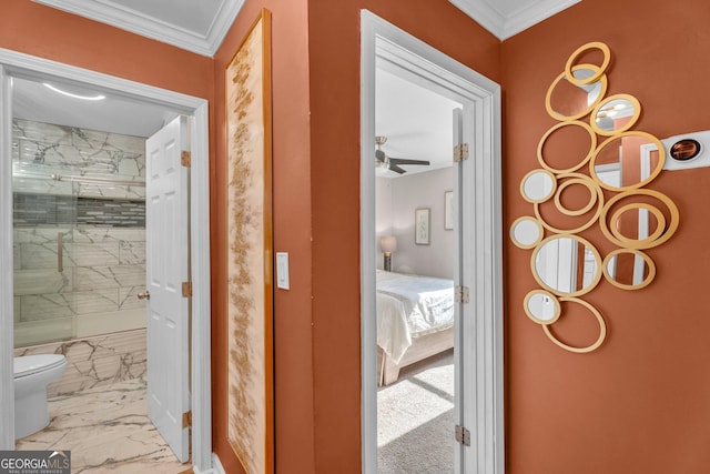 bathroom with crown molding, ceiling fan, toilet, and a tile shower