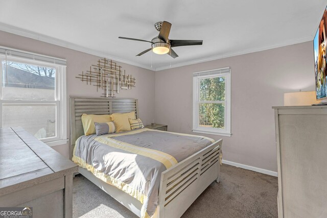 bedroom with multiple windows, light carpet, ornamental molding, and ceiling fan