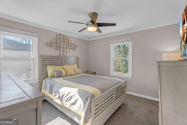 bedroom featuring crown molding, light colored carpet, and ceiling fan