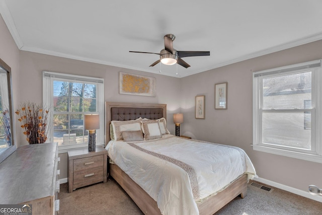 bedroom featuring ornamental molding, light carpet, and ceiling fan