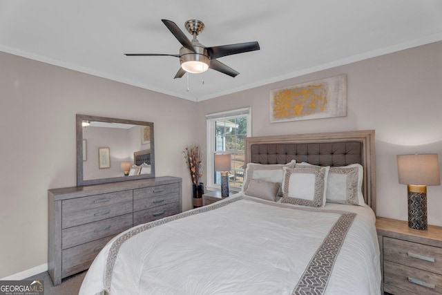 carpeted bedroom with ceiling fan and ornamental molding