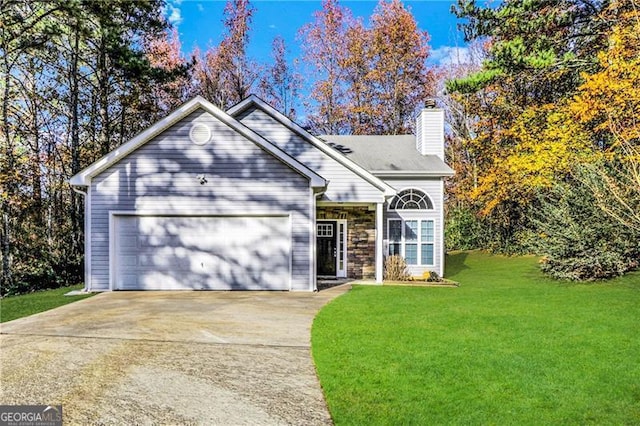 view of front property featuring a garage and a front lawn