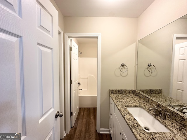 bathroom featuring bathing tub / shower combination, vanity, and wood-type flooring