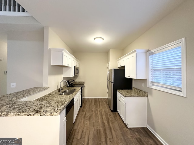 kitchen with stone counters, sink, dark hardwood / wood-style flooring, white cabinetry, and stainless steel appliances