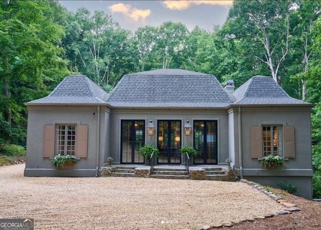 rear view of property featuring french doors