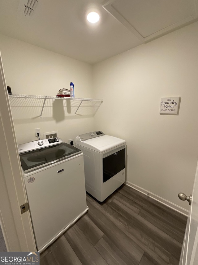 washroom featuring washer and dryer and dark hardwood / wood-style floors