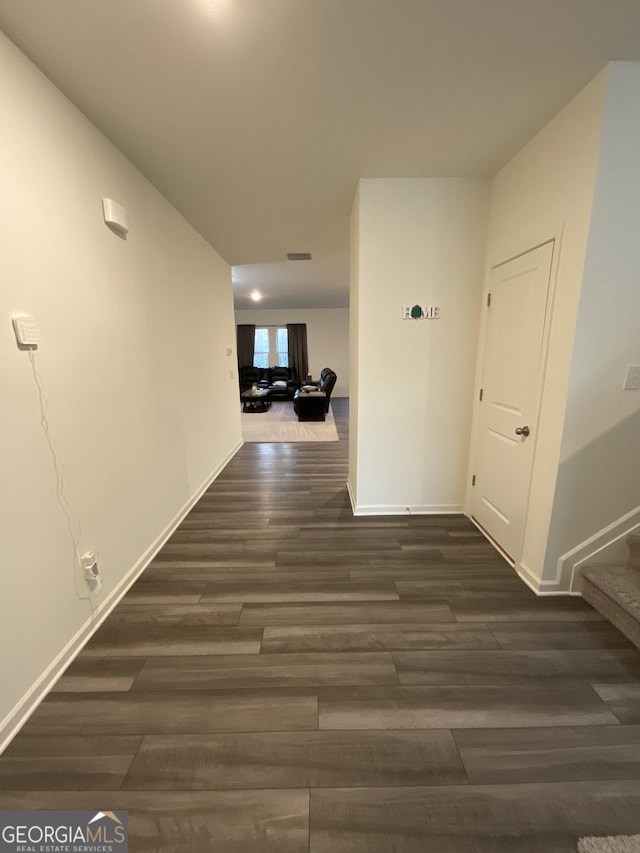 hallway featuring dark hardwood / wood-style flooring