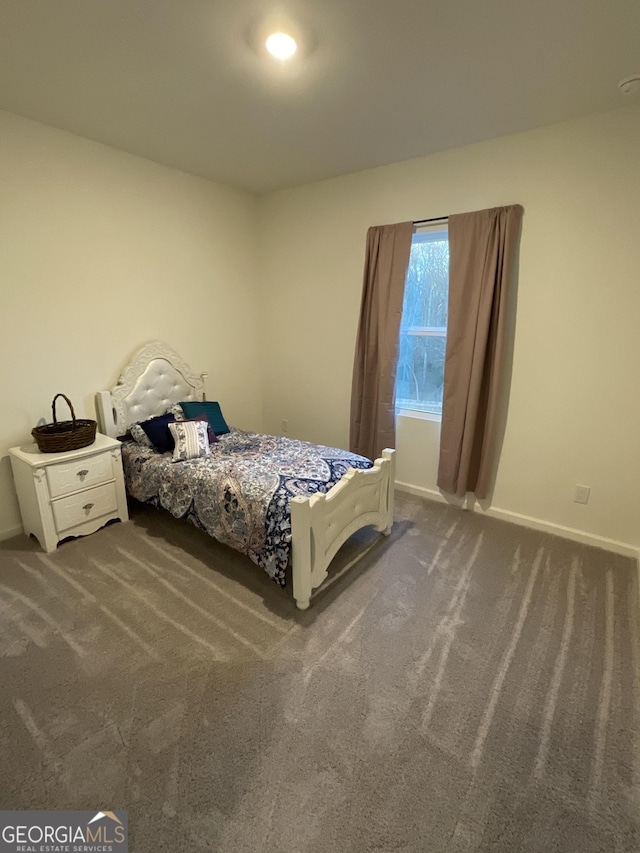 bedroom with dark colored carpet