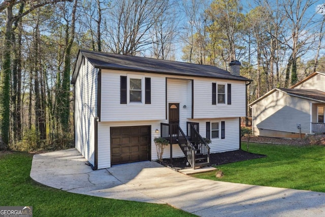 split foyer home featuring a garage and a front lawn