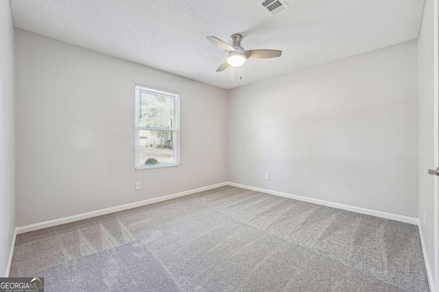 carpeted empty room with a textured ceiling and ceiling fan