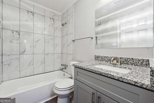 full bathroom with toilet, vanity, a textured ceiling, and tiled shower / bath