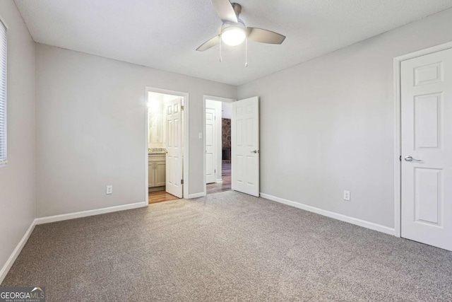 unfurnished bedroom featuring ensuite bathroom and ceiling fan