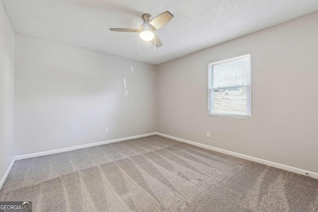 carpeted empty room with a textured ceiling and ceiling fan