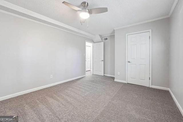 unfurnished bedroom with carpet flooring, ceiling fan, crown molding, and a textured ceiling