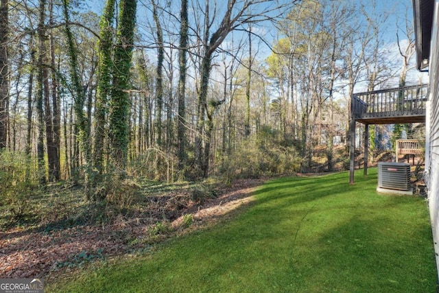 view of yard with a wooden deck and central AC unit