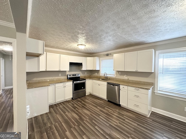 kitchen featuring white cabinetry, sink, dark wood-type flooring, crown molding, and appliances with stainless steel finishes