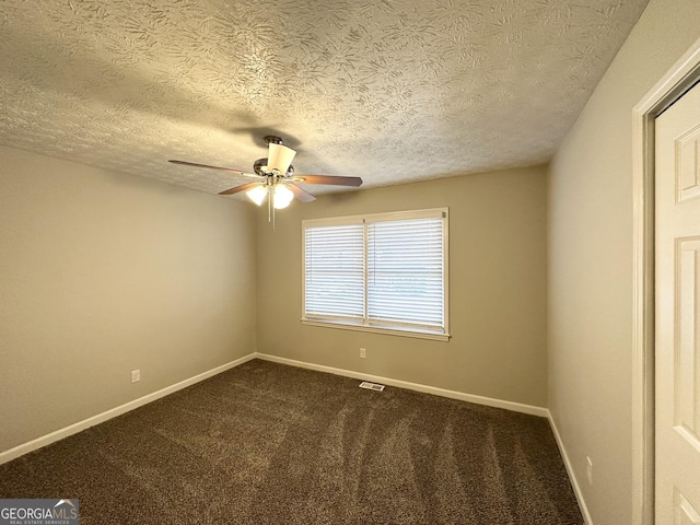 carpeted spare room with ceiling fan and a textured ceiling