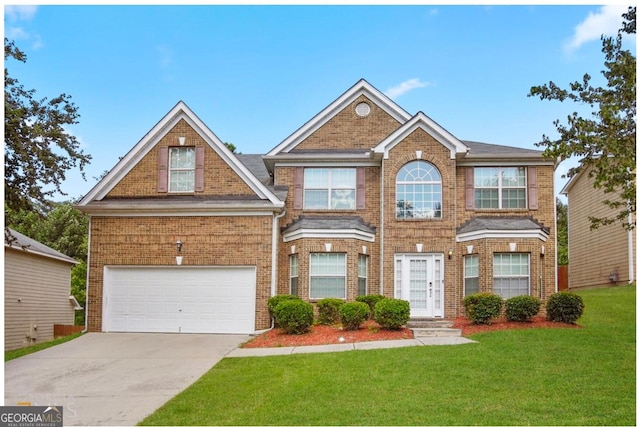 view of front of property with a front yard and a garage