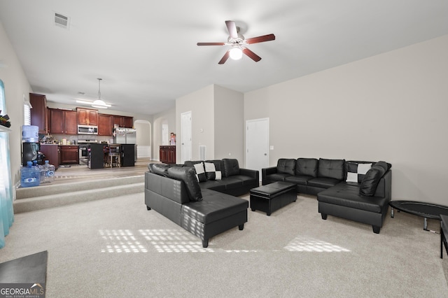 living room with ceiling fan and light carpet