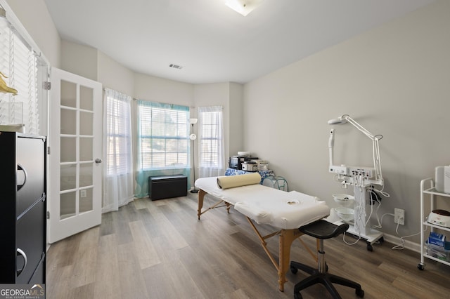 home office with wood-type flooring