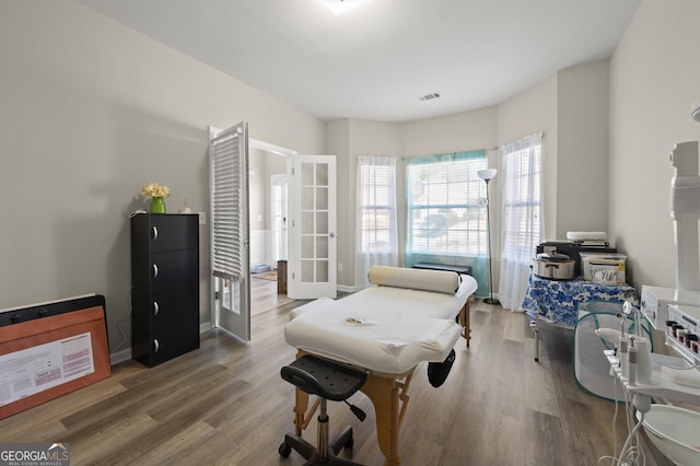 interior space with wood-type flooring and french doors