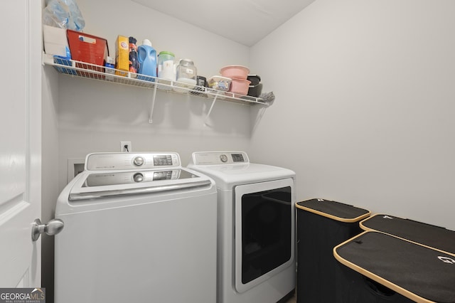 clothes washing area featuring separate washer and dryer