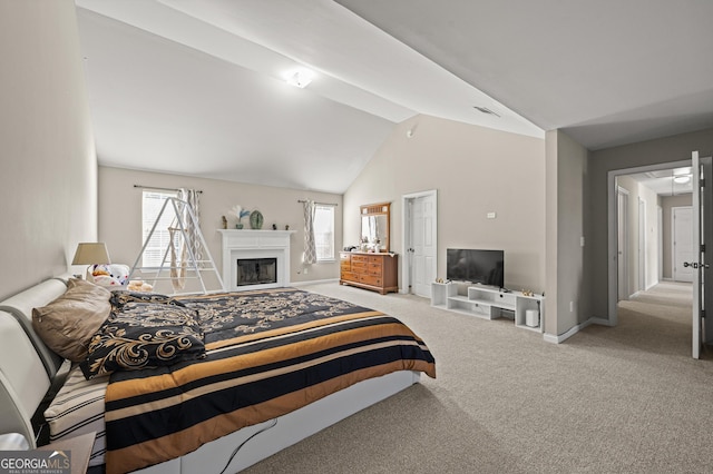 bedroom featuring multiple windows, light carpet, and vaulted ceiling