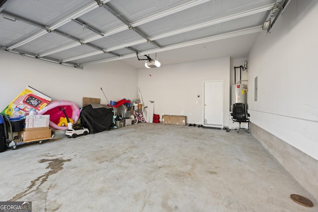 garage featuring a garage door opener and water heater