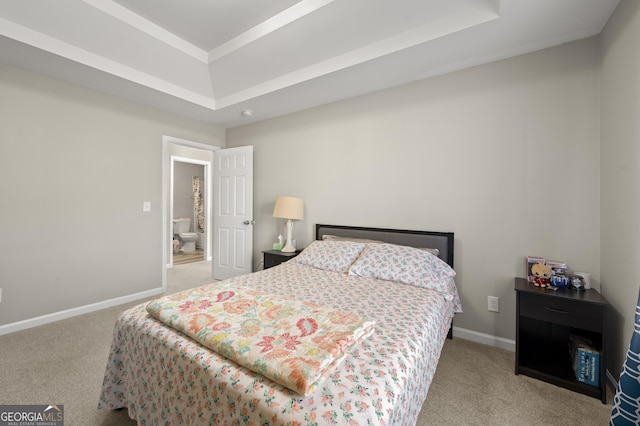 carpeted bedroom featuring a tray ceiling