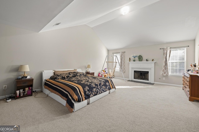 bedroom featuring vaulted ceiling and light colored carpet