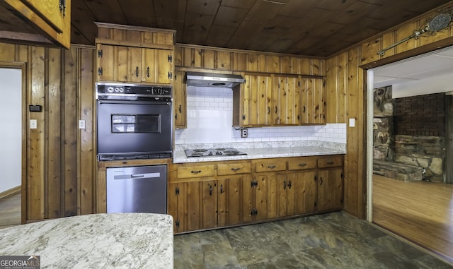 kitchen featuring wood walls, wooden ceiling, and black appliances