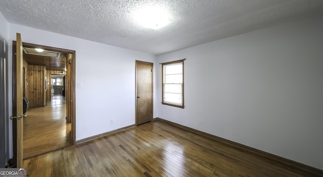 unfurnished bedroom featuring hardwood / wood-style floors and a textured ceiling