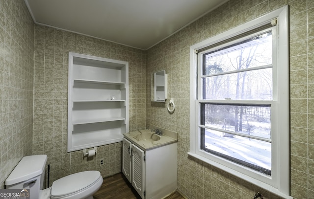 bathroom featuring hardwood / wood-style floors, vanity, toilet, and crown molding