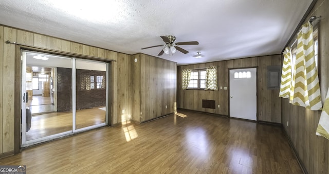 interior space featuring ceiling fan, a textured ceiling, and dark wood-type flooring