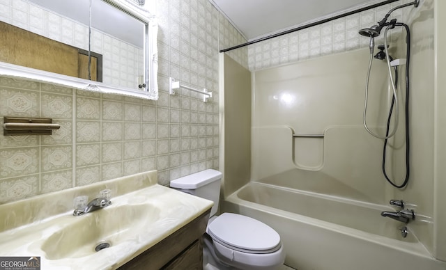 full bathroom featuring washtub / shower combination, vanity, and toilet