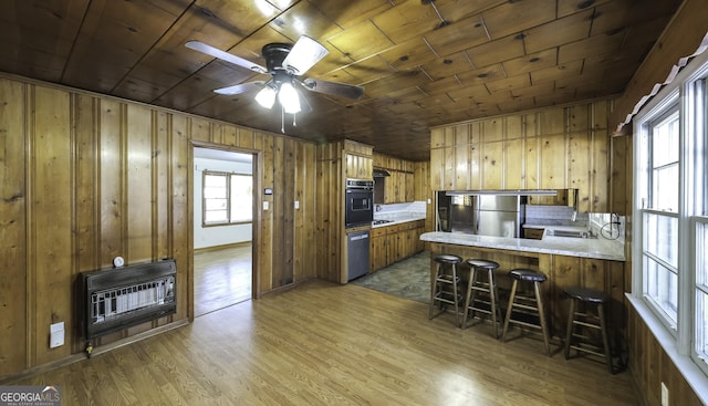 kitchen featuring wooden ceiling, dark wood-type flooring, kitchen peninsula, stainless steel appliances, and heating unit