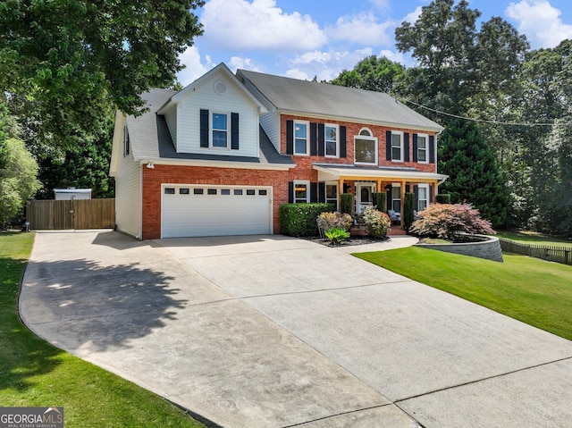 view of front of home with a garage, covered porch, and a front lawn