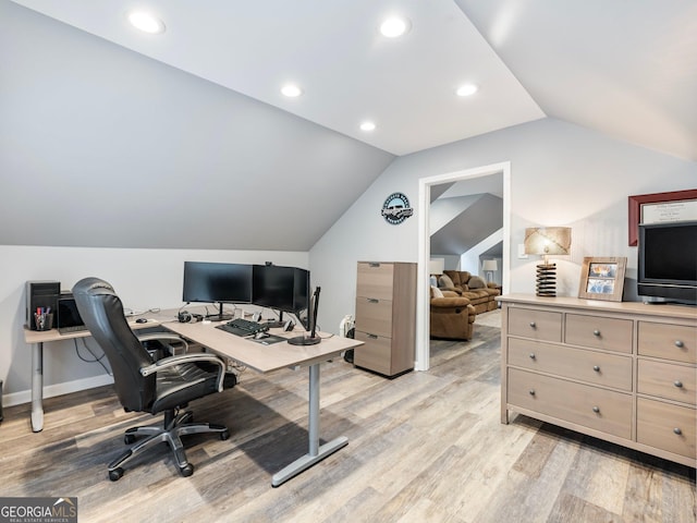 office space with vaulted ceiling and light hardwood / wood-style floors