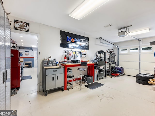 garage featuring visible vents and a workshop area