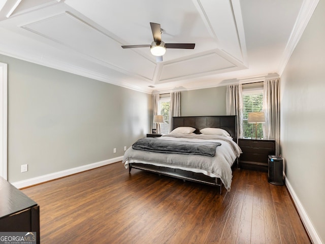 bedroom featuring baseboards, ornamental molding, a raised ceiling, and dark wood-type flooring