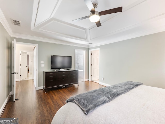 bedroom featuring dark wood-type flooring, ceiling fan, ornamental molding, and a tray ceiling