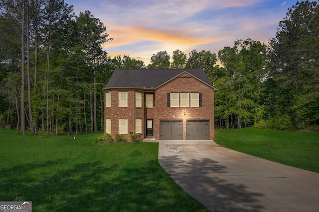 view of front facade with a lawn and a garage