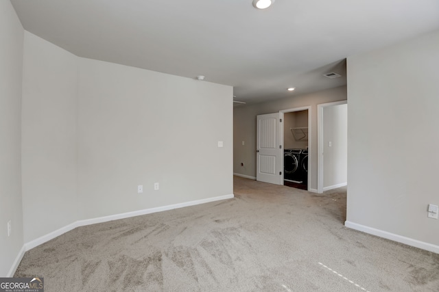 empty room with washer and clothes dryer and carpet floors