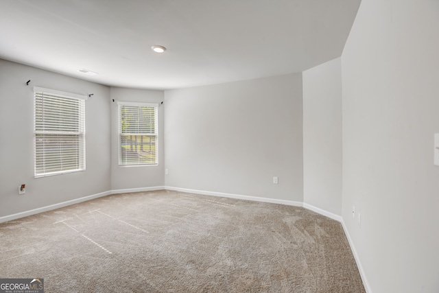 unfurnished room with light colored carpet